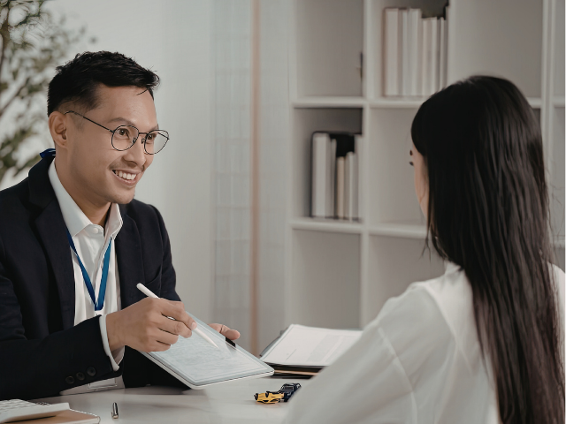 タブレットを見ながら説明するビジネスパーソン（事例②イメージ）